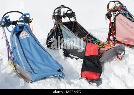 Kamchatka Peninsula: colorful sports dog sled or dog sleigh for snow sports disciplines - sled dog races, stand on white snow in clear sunny weather. Stock Photo