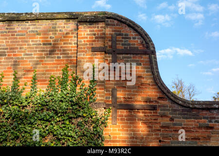 Old brick wall with metal retaining supports Stock Photo