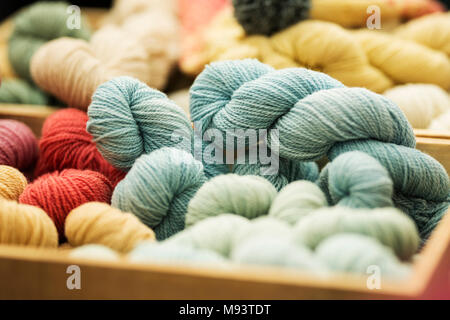 Hand-dyed artisan wool yarn for sale at a farmer's market. Stock Photo