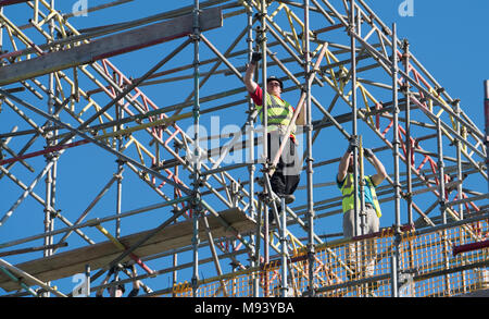 Scaffolders working on residential house under construction in East Lothian , Scotland, United Kingdom Stock Photo