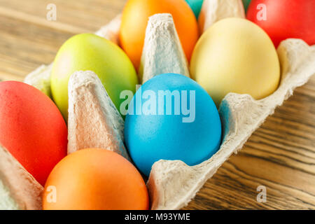 Bright Easter eggs in a special stand. Happy Easter. Close-up, blurred background. The texture of the shell. Stock Photo