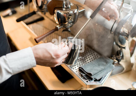 Whipping a milk with professional coffee machine Stock Photo