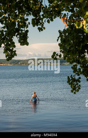 Woman taking an evening bath in a Swedish sea Stock Photo