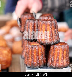 Caneles de Bordeaux made by Farro Bakery, on sale at the farmers market on Whiteladies Road, Bristol, UK Stock Photo