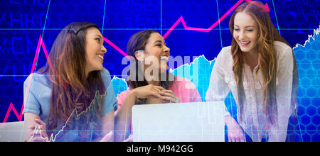 Composite image of happy female colleagues discussing over laptop Stock Photo