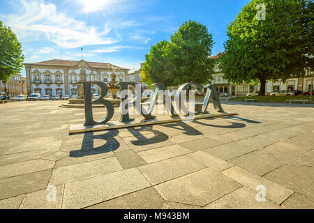 Braga, Portugal - August 12, 2017: Braga Sign or logo of city in Praca do Municipio, Braga downtown, North of Portugal. Braga City Hall on background. Sunny day in the blue sky. Stock Photo