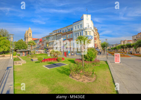 Braga, Portugal - August 12, 2017: Praca da Republica known as Arcade crossing Avenida da Liberdade with Tourist Office of Braga and Convent of Congregados on background. Cityscape in a sunny day. Stock Photo