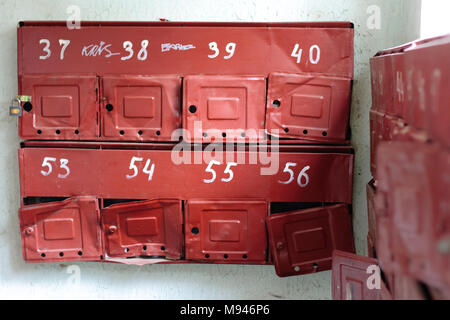 Old broken mailboxes in the entrance of the apartment building Stock Photo