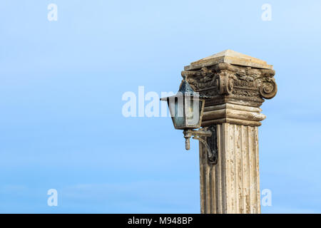 Old lamp post beside the sea Stock Photo