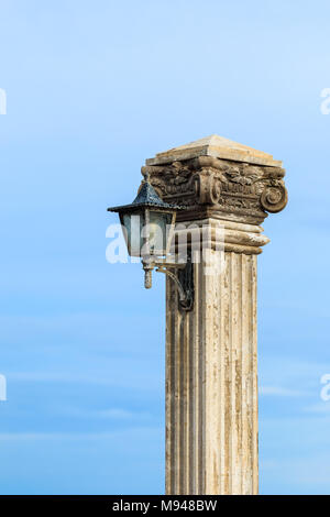 Old lamp post beside the sea Stock Photo