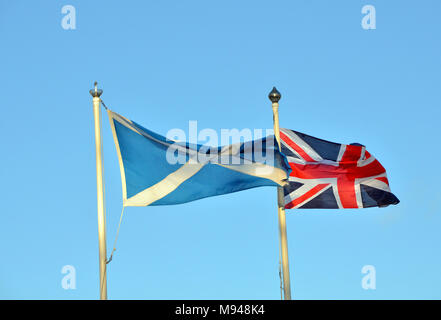 the Scottish Saltire and Union Jack flags fly next to each other. Stock Photo
