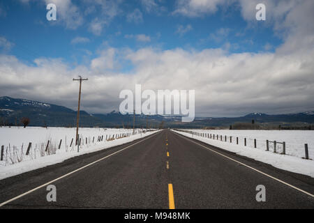 Snow has been cleared from the road on this winter route in the United States Stock Photo