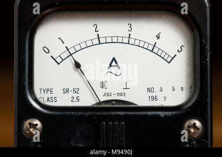 Details of an old black analog ampere meter, scale and indicator Stock Photo