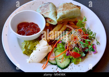 Plate of chicken quesadilla with salsa, sour cream, chips and salad. Stock Photo