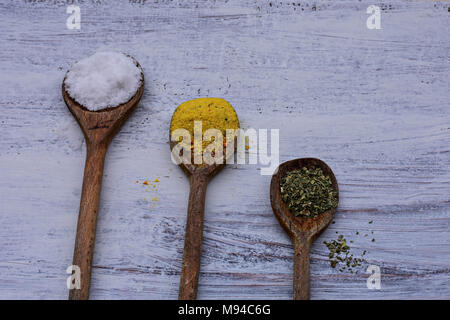 Colorful spices in spoons on white wooden background, Top view/Kitchen- Food background Stock Photo