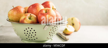Fresh apples in metal strainer Stock Photo