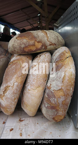Closeup of Display of large brown loafs on Moroccan stall in Almeria market, Andalusia, Spain Stock Photo