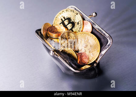 Wallet filled with two Bitcoin and many Euro coins Stock Photo