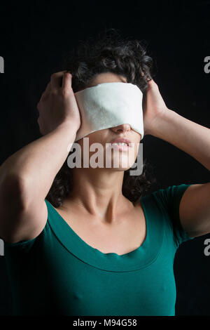 Portrait of a blindfolded woman with dark hair Stock Photo