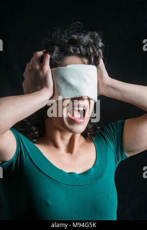 Portrait of a blindfolded woman with dark hair Stock Photo