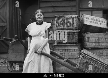 Working woman on the streets of London is shown in a vintage glass negative, ca. 1910. Stock Photo