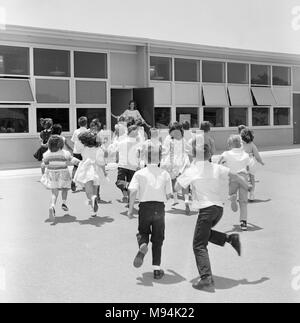 Elementary students head for the school door and class in California, ca. 1965. Stock Photo