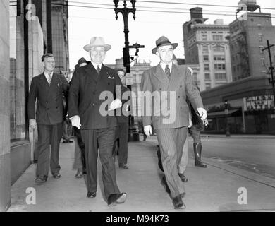 Harry S. Truman walks down a street in downtown Kansas City, Missouri shortly after being sworn in as President of the United States in 1945. Stock Photo
