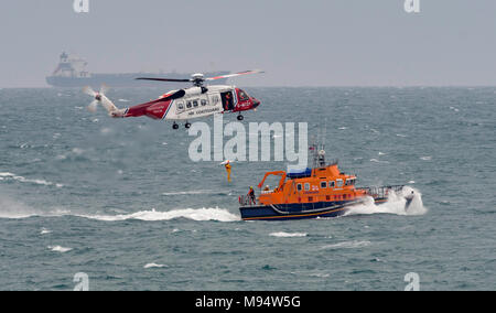 Mounts Bay, Cornwall, UK. 22nd Mar, 2018. A practice rescue/winching exercise between the RNLI Penlee Lifeboat 'Ivan Ellen' based at Newlyn in Cornwall and the Coastguard Rescue Helcopter based at Newquay. Credit: Bob Sharples/Alamy Live News Stock Photo