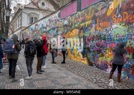 The John Lennon Memorial Wall in Velkoprevorske namesti(Grand Priory Square), Malá Strana, on 18th March, 2018, in Prague, the Czech Republic. The Lennon Wall or John Lennon Wall is a wall in Prague, Czech Republic. Once a normal wall, since the 1980s it has been filled with John Lennon-inspired graffiti and pieces of lyrics from Beatles' songs. In 1988, the wall was a source of irritation for the communist regime of Gustáv Husák. Young Czechs would write grievances on the wall and in a report of the time this led to a clash between hundreds of students and security police on the nearby Charle Stock Photo