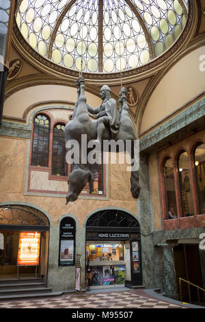 In the marbled atrium where the tickets can be bought for the cinema, hangs David Cerny’s sculpture called Kun, an equestrian sculpture of  St Wenceslas in Wenceslas Square in Lucerna Gallery, on 19th March, 2018, in Prague, the Czech Republic. Lucerna is the most elegant of Nove Mesto’s many shopping arcades runs through the art-nouveau Lucerna Palace (1920), between Stepanska and Vodickova streets. The complex was designed by Vaclav Havel (grandfather of the former president), and is still partially owned by the family. It includes theatres, a cinema, shops, a rock club and several cafes and Stock Photo