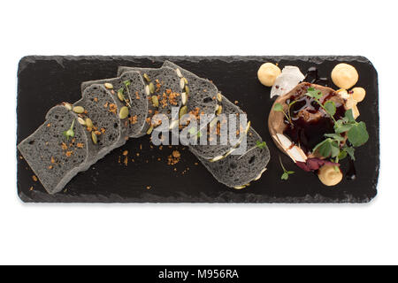 Slices of black bread with dessert on a blackboard Stock Photo