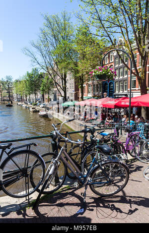 AMSTERDAM, NETHERLANDS - MAY 27, 2017: View of the Kloveniersburgwal street in the old town part of Amsterdam on May 27, 2017. Amsterdam is popular by Stock Photo