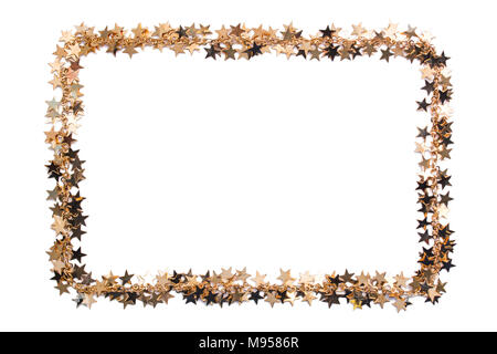 Frame of stars of confetti. Golden beads of shine stars. Festive decor on a white background. Stock Photo