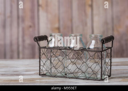 Vintage milk bottles in a wire basket carrier Stock Photo