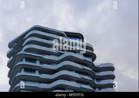 Upper part of Marco Polo Tower at daylight with blue tint. Stock Photo