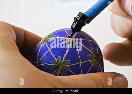 Decorating easter eggs with wax and a kistka. Stock Photo