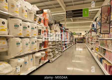 Bathroom and bedding products for sale on full shelves in an Asda supermarket. Duvets for sale, pillows, Stock Photo