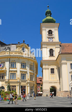 Sibiu, Transylvania, Romania. Piata Mare (square) Roman Catholic Cathedral (right) Tourist Information building (left) Stock Photo