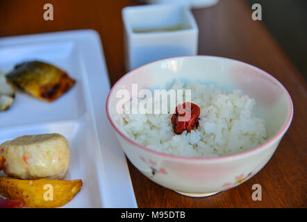 Japanese white rice and umeboshi (plum pickle) on table for lunch. Stock Photo