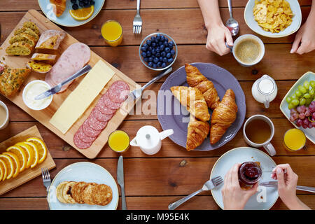 group of people having breakfast at table Stock Photo