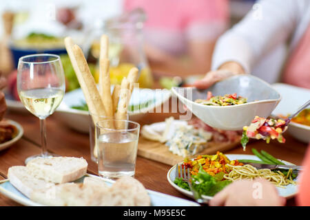 people putting salad on plate with food Stock Photo