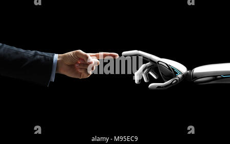 robot and human hand connecting fingers Stock Photo