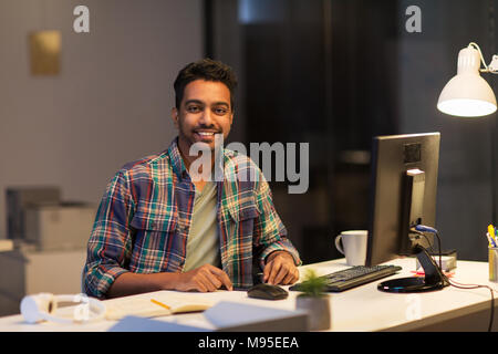 creative man with tablet pc at night office Stock Photo