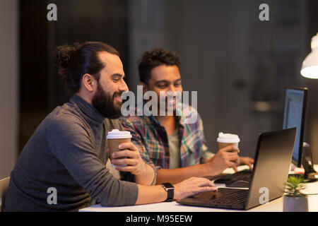 creative team drinking coffee at night office Stock Photo