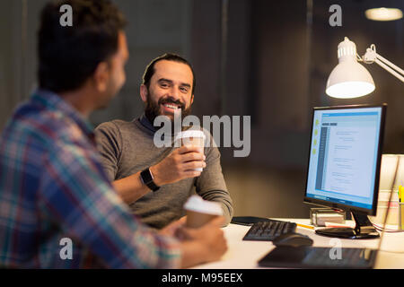 creative team drinking coffee at night office Stock Photo