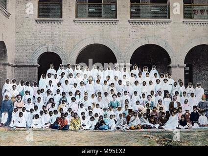 Pupils and teachers pose at the Kinnaird High School in Lahore, sometime during the late Victorian Period. Hand tinted photograph. Stock Photo