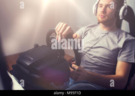 close up of man playing car racing video game Stock Photo