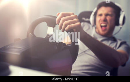 close up of man playing car racing video game Stock Photo