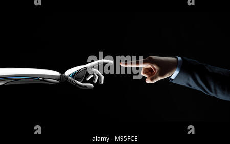 robot and human hand connecting fingers Stock Photo