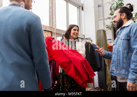 friends choosing clothes at vintage clothing store Stock Photo